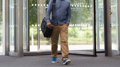 Man walking through revolving door