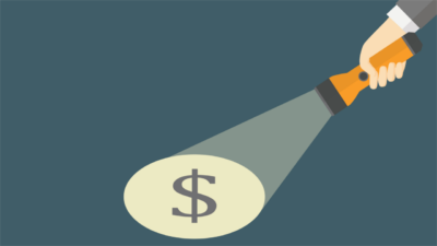 Flashlight shining on dollar sign