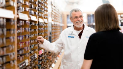 Pharmacy associate assisting customer