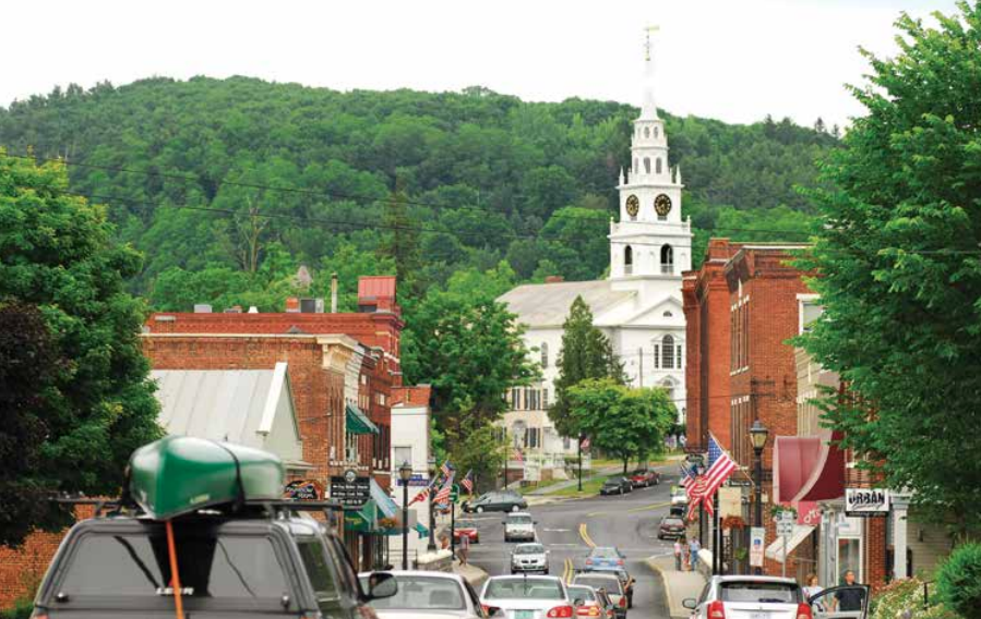 Cars driving down Main Street in small town