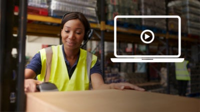 African American woman scanning boxes in a warehouse