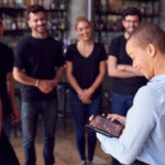 Photo of restaurant workers meeting in a circle