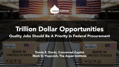 Foreground: "Trillion Dollar Opportunities: Quality Jobs Should Be A Priority in Federal Procurement" by Tomás E. Durán, Concerned Capital, and Mark G. Popovich, The Aspen Institute. Background: Photo of cardboard boxes moving down a conveyor belt. Each box is stamped with the words "Made in America." There are several American flags hanging in the background.