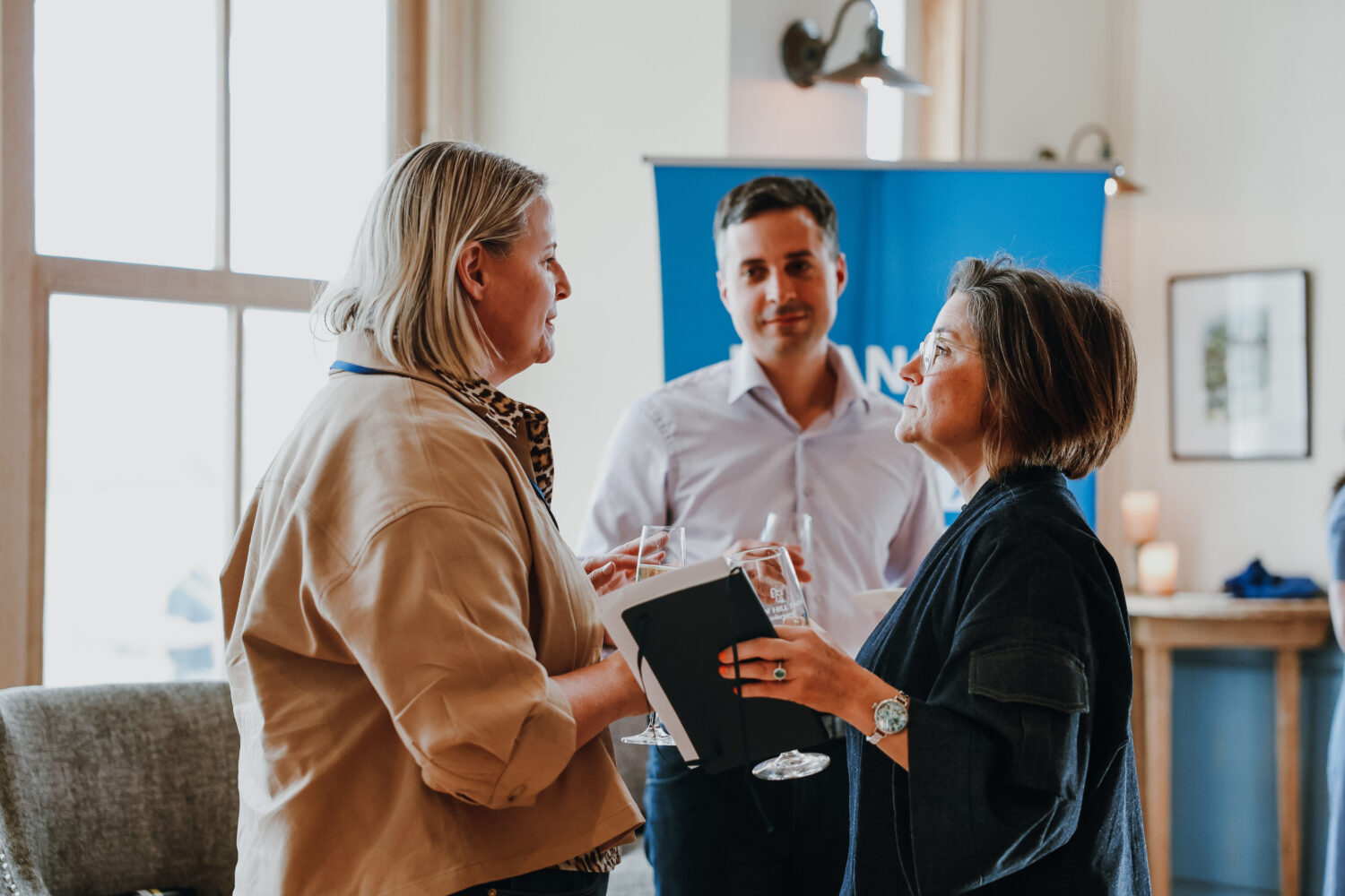 Karen Biddle Andres and Jason Ewas speak to a participant at the Aspen Leadership Forum on Retirement Savings.