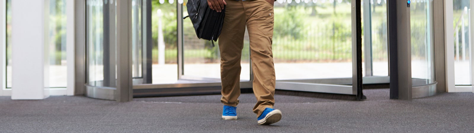 Man walking through revolving door