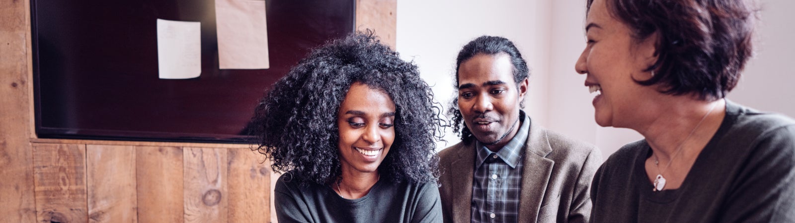 Photo of a young Black couple speaking to a financial advisor