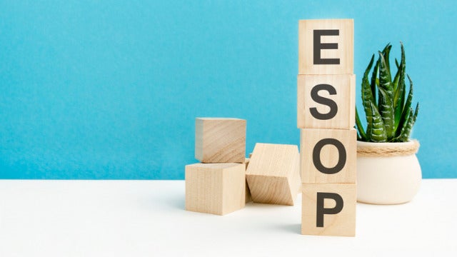 photo-close-up-of-letters-ESOP-word-is-written-on-wooden-cubes-on-a-blue-background