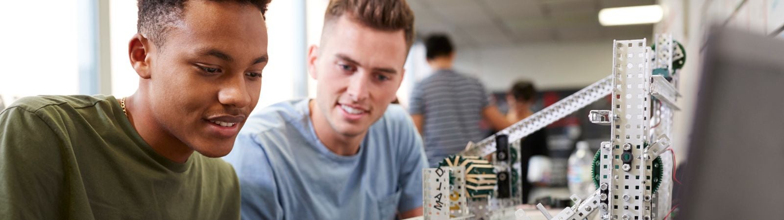 two men working on robotics or engineering project