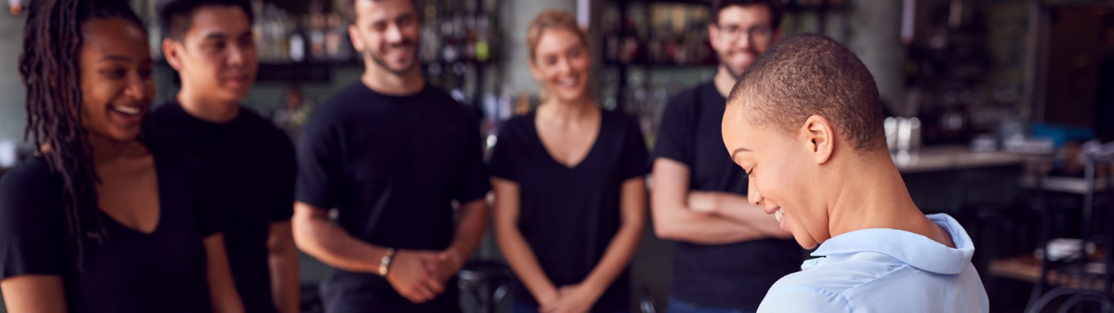 Photo of restaurant workers meeting in a circle