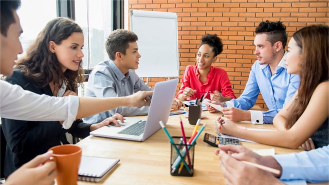 Young people meeting around a conference table