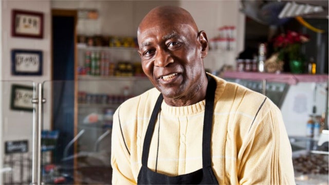 Worker behind counter in fish market