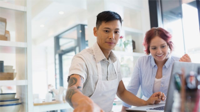 Bakery business owners working at laptop