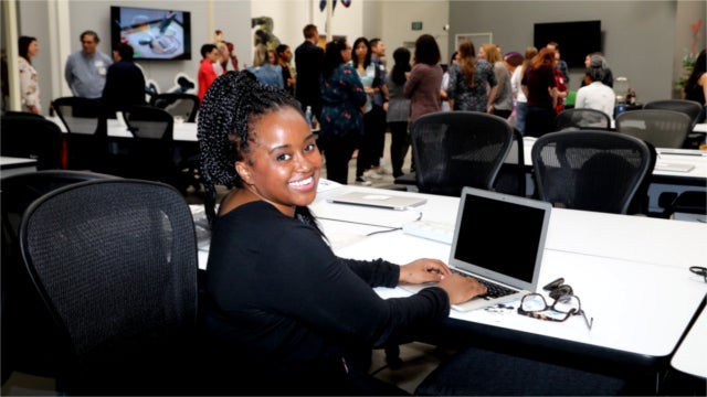 2018 CODE: Rosie participant Angela Alexander sitting in front of a laptop.