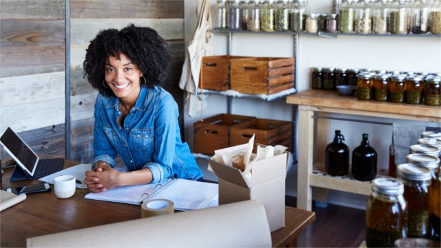 Woman standing behind counter at a retail store