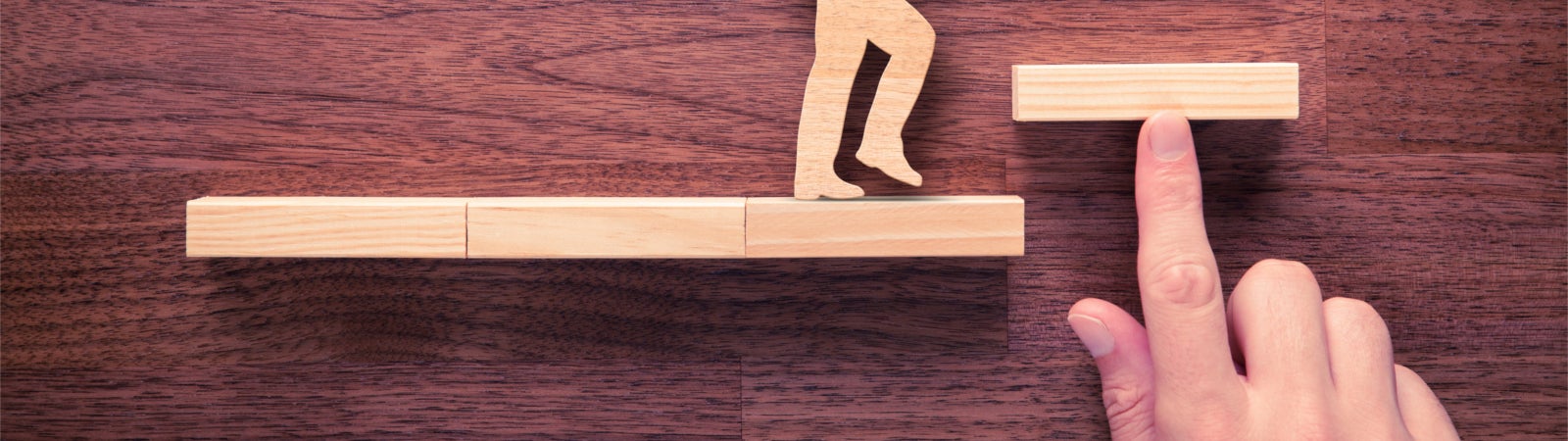 Wood cutout of a person walking up steps.