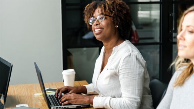 Smiling woman on computer