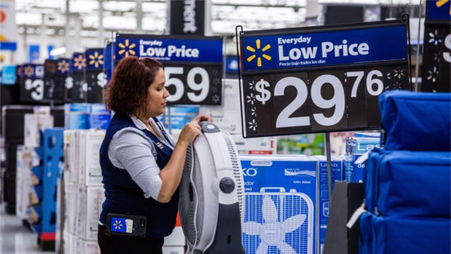 Walmart employee setting up a store display. (Photo: Timothy Fadek/Bloomberg News)