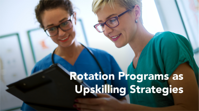 Close up view of two professional nurses with eyeglasses checking the patient papers in a doctors office, overlayed with text: "Rotation Programs as Upskilling Strategies"
