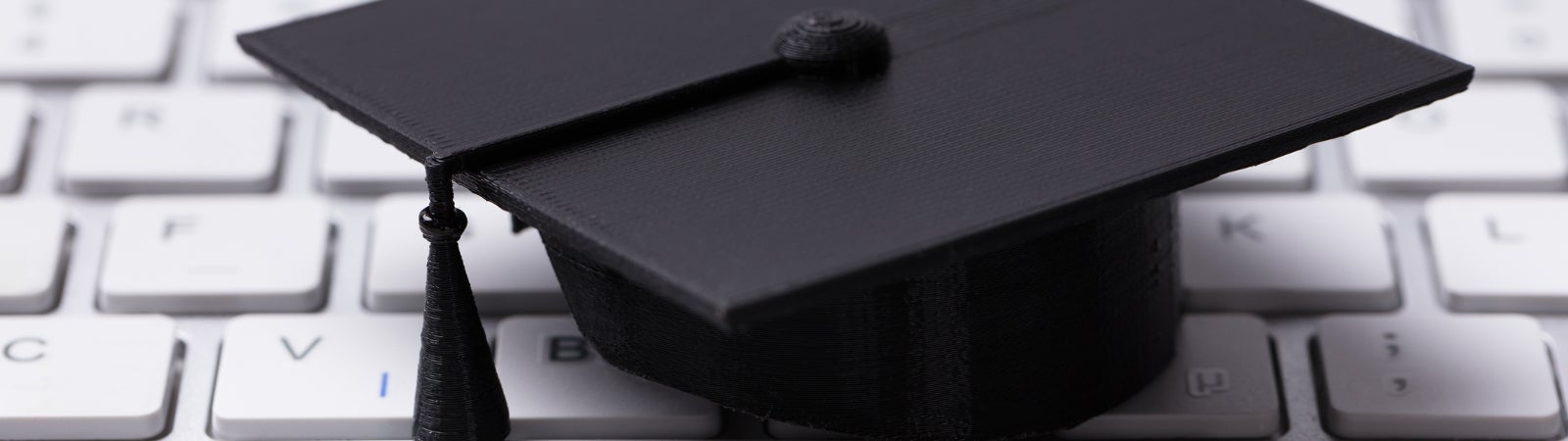 Small graduation cap on a computer keyboard
