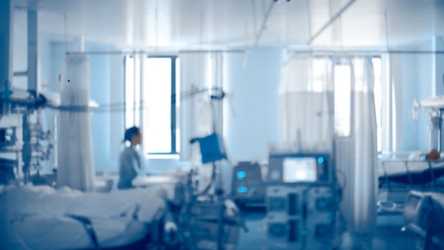 Person in blurred hospital room