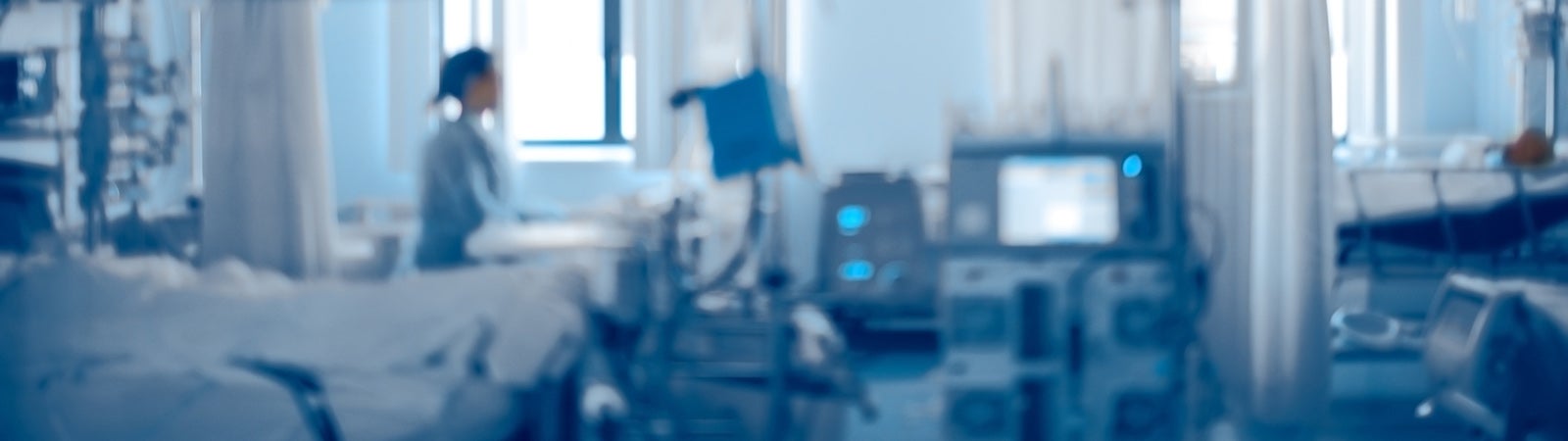 Person in blurred hospital room