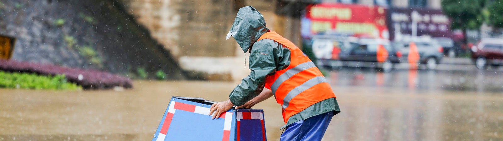 Worker on flooded street