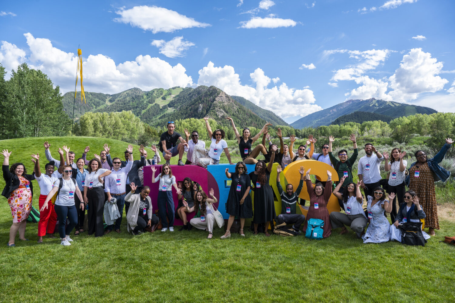 Aspen Ideas Festival Fellows gather by the Ideas sign. 
