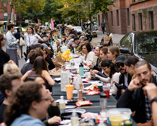 In the Chelsea neighborhood of New York City, neighbors take weaving into the street. Photo credit: The Longest Table