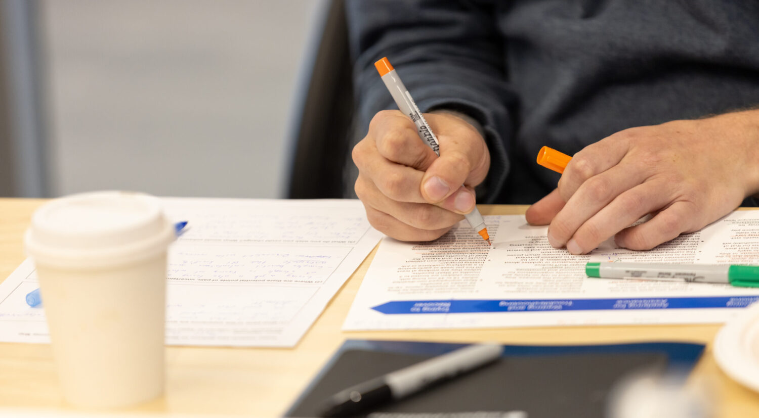 A person writing notes on a piece of paper