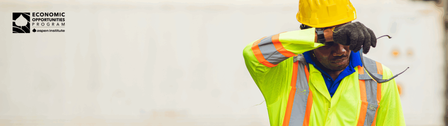 A photo shows a construction worker in a neon safety vest and yellow hard hat wiping sweat from his face, evoking themes of heat exposure, labor, and workplace risk.